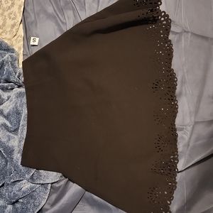Black, slightly above the knee, skirt